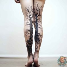 a woman's legs with tree tattoos on them and the bottom part of her leg