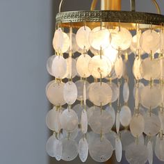 a chandelier hanging from a ceiling with lots of glass discs attached to it