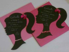 the silhouettes of two women are on pink and black paper, with pearls in their hair