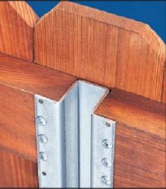 a close up of a wooden door with metal hinges on the bottom part