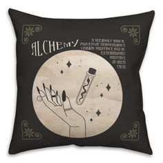 a black pillow with an illustration of a hand holding a pen and stars on it