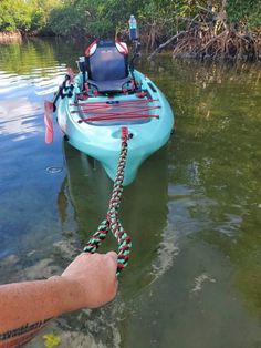 a person is holding onto a rope attached to a kayak