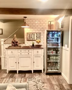 an open refrigerator in a kitchen next to a table with food on it and a rug