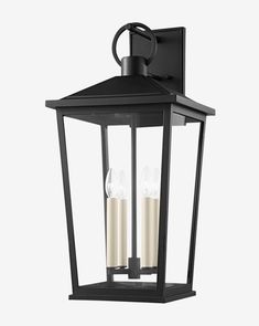 an outdoor wall light with three candles on it