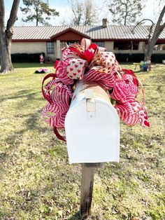 a mailbox decorated with red and white bows