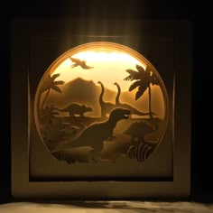 a light that is inside of a box with some dinosaurs in the middle of it