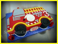 a cake shaped like a firetruck on top of a table