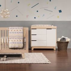 a baby's room with a crib and dresser