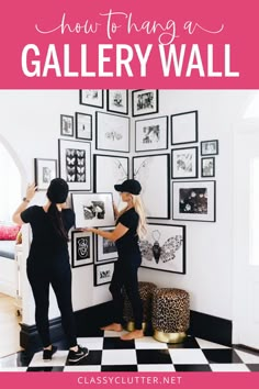 two women standing in front of a gallery wall