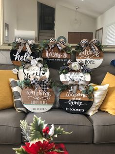 christmas decorations are on display in front of a couch with the words welcome home written on it