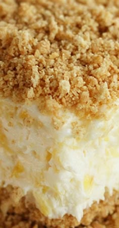 a close up of a dessert with crumbs on the top and white frosting