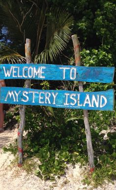 a blue sign that says welcome to mystery island