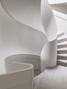 a white spiral staircase in a modern building