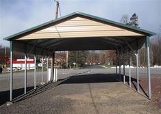 an empty covered parking lot next to a road