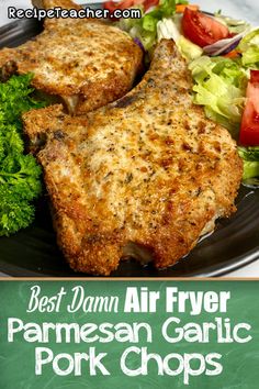 the best damn air fryer parmesan garlic pork chops on a black plate