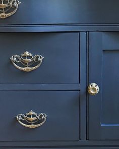 a blue dresser with gold handles and knobs