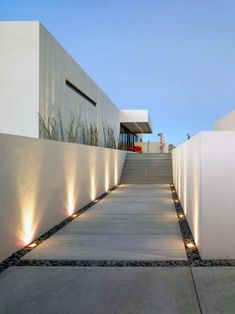 the walkway is lined with white walls and lights