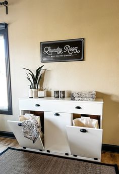 a white cabinet with drawers and plants in it