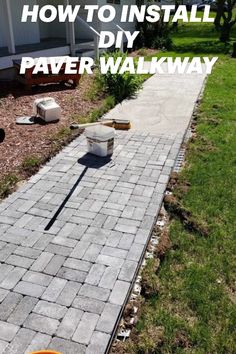 an orange bucket sitting on top of a brick walkway next to a white house with the words how to install a diy paver walk way