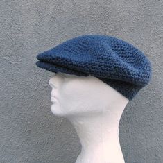 a white mannequin head wearing a blue knitted hat