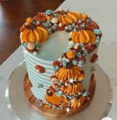 a blue and white cake with orange decorations on it