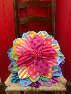 a chair that has some paper flowers on it