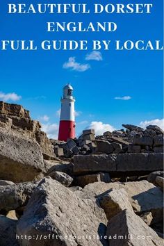 a red and white lighthouse on top of rocks with the words beautiful dorset england full guide by local