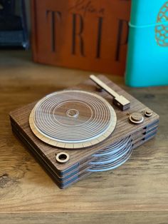 a wooden record player sitting on top of a table