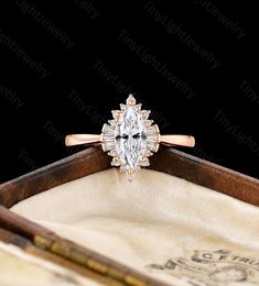 an oval cut diamond engagement ring in a wooden box