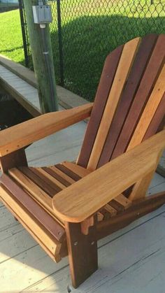 a wooden chair sitting on top of a dock