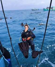 a man is in the water while holding onto a rope to go parasailing