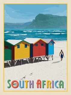 there is a man walking on the beach next to some colorful huts that say south africa