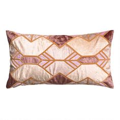 a pink and gold pillow on a white background