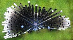 an overhead view of several metal pipes in the grass