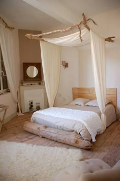 a bedroom with white bedding and curtains