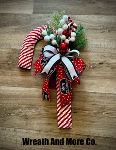 a wreath and more co christmas decorations on a wooden floor