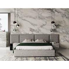 a bedroom with marble walls and flooring in the background, there is a bed that has two lamps hanging above it