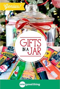 a jar filled with candy next to a christmas tree