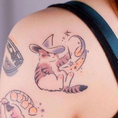 a woman's arm with tattoos on it and an image of a cat in a hat