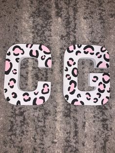 the letters g and c are made out of leopard print material, with pink accents