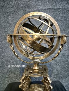 an antique brass plated globe on display