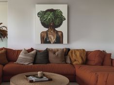 a living room filled with furniture and a painting on the wall above it's head