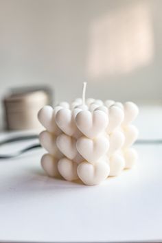 a white candle sitting on top of a table