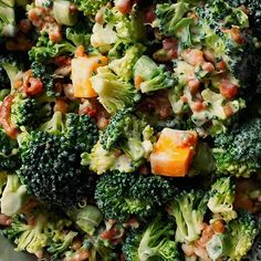 broccoli and other vegetables are mixed together in a salad with dressing on the side