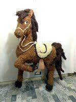 a stuffed horse sitting on the floor next to a wall