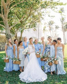 a bride and her bridal party in blue dresses