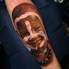 a man's arm with a portrait of him painted on it and his face