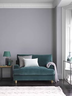 a living room with grey walls and furniture