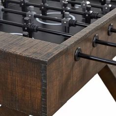 a close up of a foosball table with metal handles and black knobs