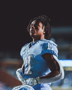 a football player with dreadlocks on his face